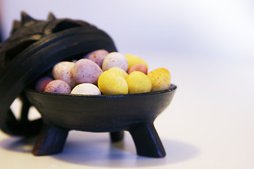 Image showing Mini candy chocolate eggs in a decorative tripod dish