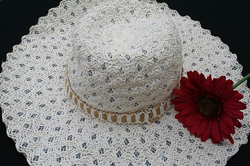 Image showing White hat and red flower
