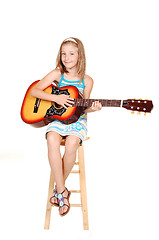 Image showing Young blond girl with guitar.