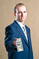 Image showing  A man in a suit with money