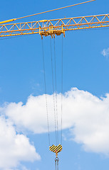 Image showing Crane hook over blue sky with clouds