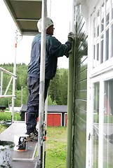 Image showing Man painting a house