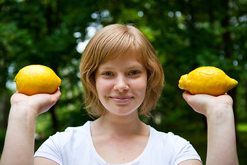 Image showing Girl holding lemons