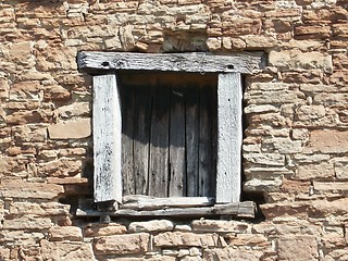 Image showing The old wooden window in a stone house