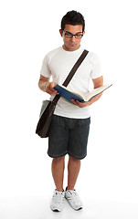 Image showing Standing student reading book studying