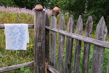 Image showing Clay Pots and Towel on the Fence