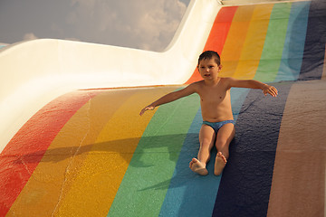 Image showing Boy on colorful water slide