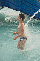 Image showing Little boy under water jet