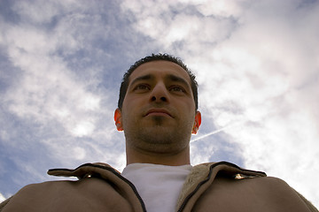 Image showing Man Looking up with the Clouds on the Background