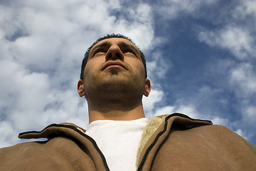 Image showing Man Looking up with the Clouds on the Background