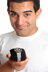 Image showing Man holding a chronograph wrist watch