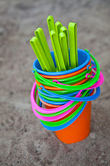 Image showing Colourful buckets on a sandy beach