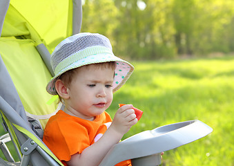 Image showing baby eating outdoor