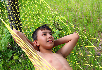 Image showing boy relaxing in hammock