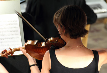 Image showing woman playing on violin in orchestra