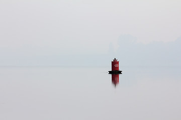 Image showing red buoy on river in mist