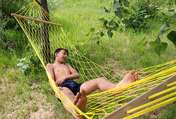 Image showing boy relaxing in hammock