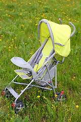 Image showing baby stroller on green lawn