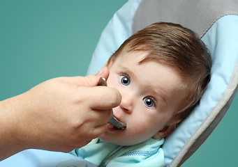 Image showing baby feeding by mother