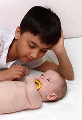 Image showing asian boy and caucasian baby