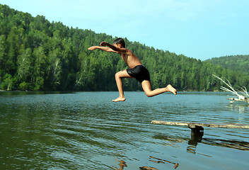 Image showing boy jumping in lake