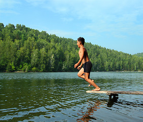 Image showing boy jumping in lake