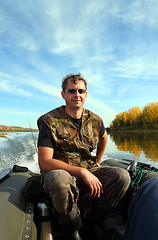 Image showing man on inflatable boat with motor