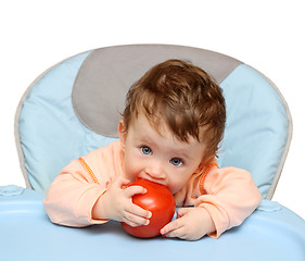 Image showing small baby biting tomato