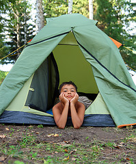 Image showing thoughtful boy in camping tent