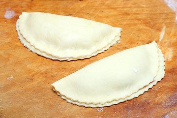 Image showing raw patty on wooden board