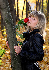 Image showing girl with rose in autumn park