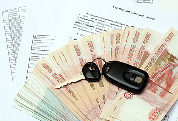 Image showing car keys and money on credit contract
