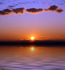 Image showing sunrise with clouds over sea