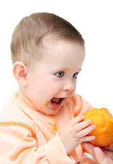 Image showing sitting baby eating peach