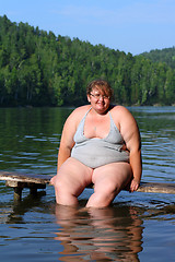 Image showing overweight woman sitting on stage