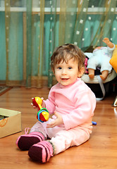 Image showing baby girl with toy on floor