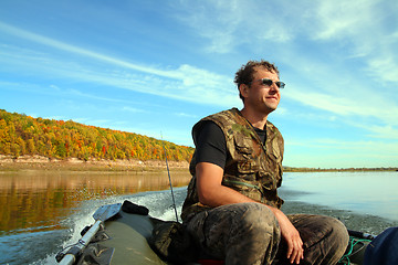 Image showing man on inflatable boat with motor