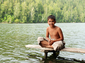 Image showing boy sitting on stage