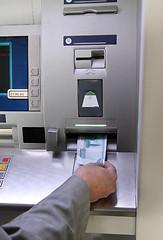 Image showing hand inserting banknote into cash dispense