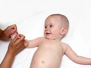 Image showing smiling baby massaging