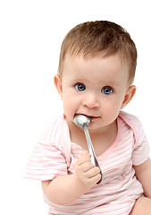 Image showing lbaby sucking spoon