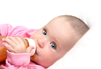 Image showing baby drinking juice form bottle