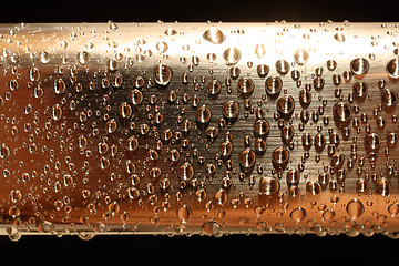 Image showing water drops on golden metal