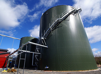 Image showing industrial pipelines on pipe-bridge against blue sky 