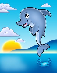 Image showing Cute jumping dolphin with sunset