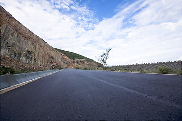 Image showing Asphalt road blue sky with clouds and mountains 