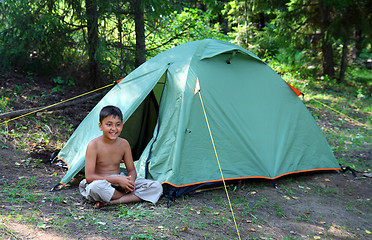 Image showing smiling boy near tent