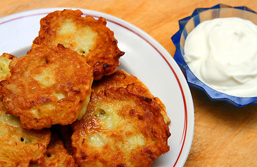 Image showing potato pancakes with sour cream