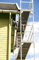 Image showing Man painting a house