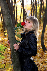 Image showing girl with rose in autumn park